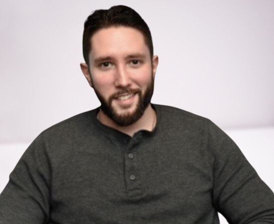 Jared Carrabis smiling while hosting a baseball sports show.