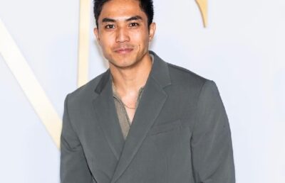 Trevor Salter smiling in a formal suit at a red carpet event, 2025