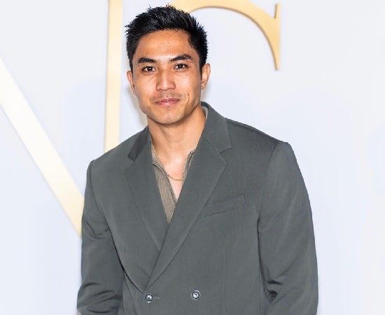 Trevor Salter smiling in a formal suit at a red carpet event, 2025