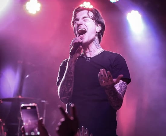 Jordan Lutes performing live in 2025 with edgy fashion and tattoos visible.