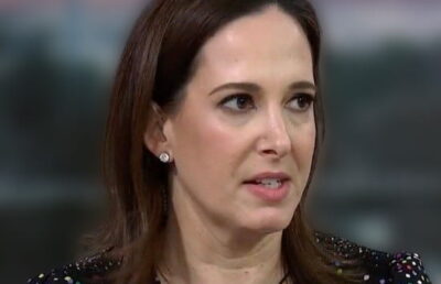 Lisa Rubin smiling during MSNBC interview segment in 2024
